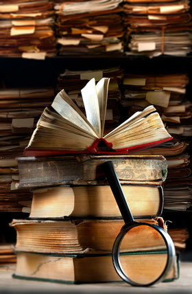 Old books with magnifying glass
